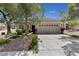 Inviting single-story home showcasing a large driveway and desert landscaping at 2029 Poppywood Ave, Henderson, NV 89012