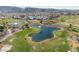 Scenic aerial view of the lush golf course with water features and mountain views at 2029 Poppywood Ave, Henderson, NV 89012