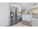 Stylish kitchen featuring stainless steel refrigerator and modern cabinetry with white countertops at 2029 Poppywood Ave, Henderson, NV 89012