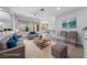 Staged living room with tile floors, neutral walls, and bright natural light at 2029 Poppywood Ave, Henderson, NV 89012