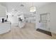 Bright open-concept living area featuring modern lighting and wood-look tile flooring at 2029 Poppywood Ave, Henderson, NV 89012