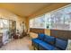 Relaxing patio with stylish blue cushions, neutral tile floor, and peaceful views through sheer window coverings at 2050 W Warm Springs Rd # 3211, Henderson, NV 89014