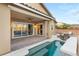 Covered patio, sparkling pool, and a cozy seating area, perfect for outdoor entertaining at 2116 Canvas Edge Dr, Henderson, NV 89044
