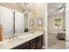 Bathroom with dual sinks and framed mirrors, adjacent to a bedroom at 2116 Canvas Edge Dr, Henderson, NV 89044