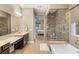 Elegant bathroom with a soaking tub, a separate glass-enclosed shower, and dual vanities at 2116 Canvas Edge Dr, Henderson, NV 89044