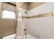 Well-lit bathroom featuring a shower-tub combination with white tiled walls at 2116 Canvas Edge Dr, Henderson, NV 89044