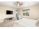 Airy bedroom with ceiling fan, TV and large window showing backyard pool area at 2116 Canvas Edge Dr, Henderson, NV 89044