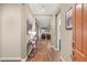 Stylish entryway featuring wood-look tile flooring, modern console table, and views into the living spaces at 2116 Canvas Edge Dr, Henderson, NV 89044