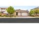 Charming single-story home featuring a two-car garage, well-maintained landscaping, and a red tile roof at 2116 Canvas Edge Dr, Henderson, NV 89044