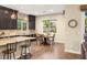 Charming kitchen featuring dark wood cabinets, granite countertops, and a view to the backyard at 2116 Canvas Edge Dr, Henderson, NV 89044