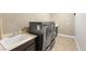 Well-equipped laundry room with modern washer and dryer and convenient sink area at 2116 Canvas Edge Dr, Henderson, NV 89044