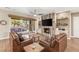 Stylish living room with fireplace, built-ins, wood floors, and a sliding glass door to the patio at 2116 Canvas Edge Dr, Henderson, NV 89044
