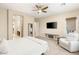 A bright main bedroom with a ceiling fan, walk-in closet, and access to a private bathroom at 2116 Canvas Edge Dr, Henderson, NV 89044