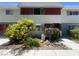 Charming townhome featuring colorful landscaping and a well-maintained front yard at 225 Greenbriar Townhouse Way, Las Vegas, NV 89121