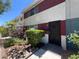 Inviting townhome exterior with decorative front door and manicured landscaping at 225 Greenbriar Townhouse Way, Las Vegas, NV 89121