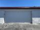 Closed white garage door for a two-car garage with a blue sky background at 225 Greenbriar Townhouse Way, Las Vegas, NV 89121