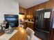 Cozy kitchen featuring a breakfast table, wooden cabinets and a stainless refrigerator at 225 Greenbriar Townhouse Way, Las Vegas, NV 89121