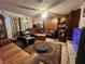 Cozy living room with plush seating, a ceiling fan, and a stone fireplace at 225 Greenbriar Townhouse Way, Las Vegas, NV 89121