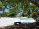 Community pool surrounded by lush trees with a stone bench at 225 Greenbriar Townhouse Way, Las Vegas, NV 89121