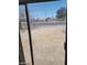 View of the backyard through sliding glass doors, showing the outdoor space at 2417 St George St, North Las Vegas, NV 89030