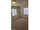 Bedroom with carpet and two windows covered with white blinds at 2417 St George St, North Las Vegas, NV 89030