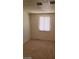 A carpeted bedroom featuring a window with blinds and neutral walls at 2417 St George St, North Las Vegas, NV 89030