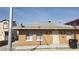 Single-story home featuring a brick facade, windows, and a security door, presenting a simple design at 2417 St George St, North Las Vegas, NV 89030