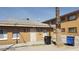 Simple single-story home with tan brick, functional windows, and a protective security screen door at 2417 St George St, North Las Vegas, NV 89030