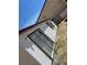 Close-up view of a white house exterior, highlighting the simple design and functional windows at 2417 St George St, North Las Vegas, NV 89030