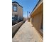 Side exterior view of a tan single story home with gravel landscaping at 2417 St George St, North Las Vegas, NV 89030