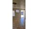 Bright room featuring tile floors, windows, and an open doorway, offering functionality at 2417 St George St, North Las Vegas, NV 89030