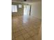 Open living area with tiled flooring, illuminated by natural light from the windows and an open doorway at 2417 St George St, North Las Vegas, NV 89030