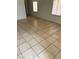 Bright living room featuring neutral-toned tiled flooring, creating a clean and spacious atmosphere at 2417 St George St, North Las Vegas, NV 89030