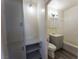 Bathroom with vanity, toilet, and tub, plus shelving for storage at 26 E Atlantic Ave, Henderson, NV 89015