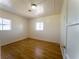 Sunlit bedroom featuring wood-look floors, neutral walls, and dual windows for natural light at 26 E Atlantic Ave, Henderson, NV 89015
