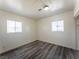 Bedroom with new floors, two windows and white walls at 26 E Atlantic Ave, Henderson, NV 89015