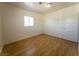 Bright bedroom with a window, wood flooring, neutral walls and a white door at 26 E Atlantic Ave, Henderson, NV 89015