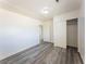 Spacious bedroom with grey wood flooring, a sliding door closet, and white walls at 26 E Atlantic Ave, Henderson, NV 89015