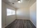 Bedroom boasting a window and modern wood-look flooring and neutral walls at 26 E Atlantic Ave, Henderson, NV 89015
