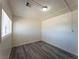 Cozy bedroom with a bright window, neutral walls, and grey wood flooring at 26 E Atlantic Ave, Henderson, NV 89015
