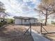 Charming single-story home featuring a fenced yard and sidewalk leading to the front door at 26 E Atlantic Ave, Henderson, NV 89015