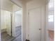 Hallway with grey wood flooring leading to a bathroom and bedroom with white walls at 26 E Atlantic Ave, Henderson, NV 89015