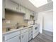 Bright kitchen features white cabinets, double sink, and an electric stove at 26 E Atlantic Ave, Henderson, NV 89015