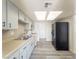 Kitchen features white cabinets, new floors, and a black refrigerator at 26 E Atlantic Ave, Henderson, NV 89015