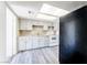 Bright kitchen with white cabinets, new floors, and black refrigerator at 26 E Atlantic Ave, Henderson, NV 89015