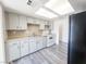 Spacious kitchen with white cabinets, new floors, and good natural light at 26 E Atlantic Ave, Henderson, NV 89015