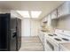 Functional kitchen featuring bright cabinets, updated appliances, and ample counter space at 26 E Atlantic Ave, Henderson, NV 89015