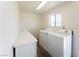 Bright laundry area features side by side washer and dryer and storage at 26 E Atlantic Ave, Henderson, NV 89015