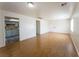 Open living room with hardwood floors seamlessly leading to the kitchen and front entry at 26 E Atlantic Ave, Henderson, NV 89015