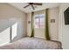 Comfortable bedroom with a ceiling fan, large window with sheer curtains, and soft carpeting at 262 Inflection St, Henderson, NV 89011